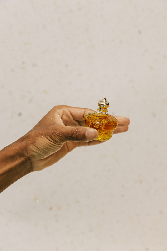 Man's Hand Holding a Bottle of Skincare
