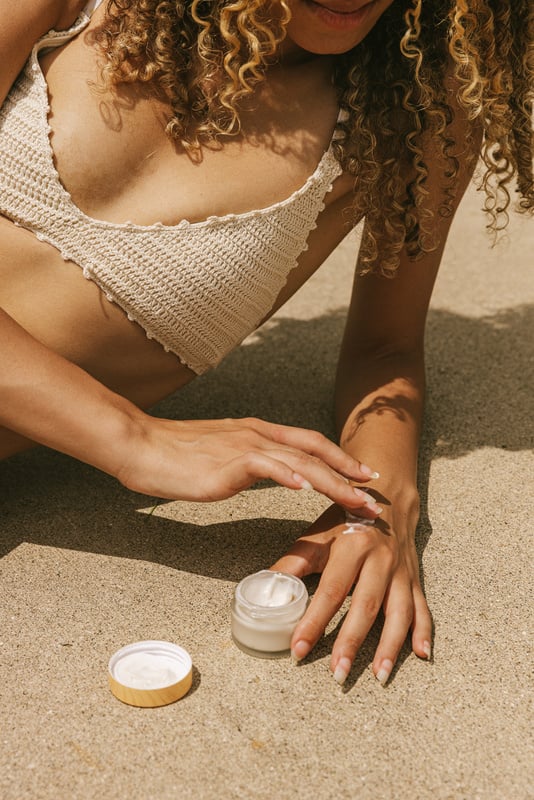 Woman Applying Cream on Hand